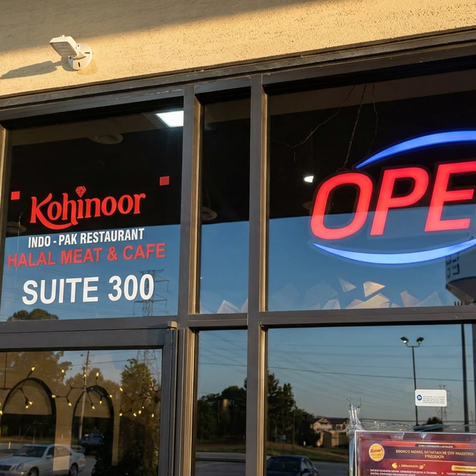 Kohinoor Indo-Pak halal meat and café storefront with glowing OPEN sign and Suite 300 lettering.